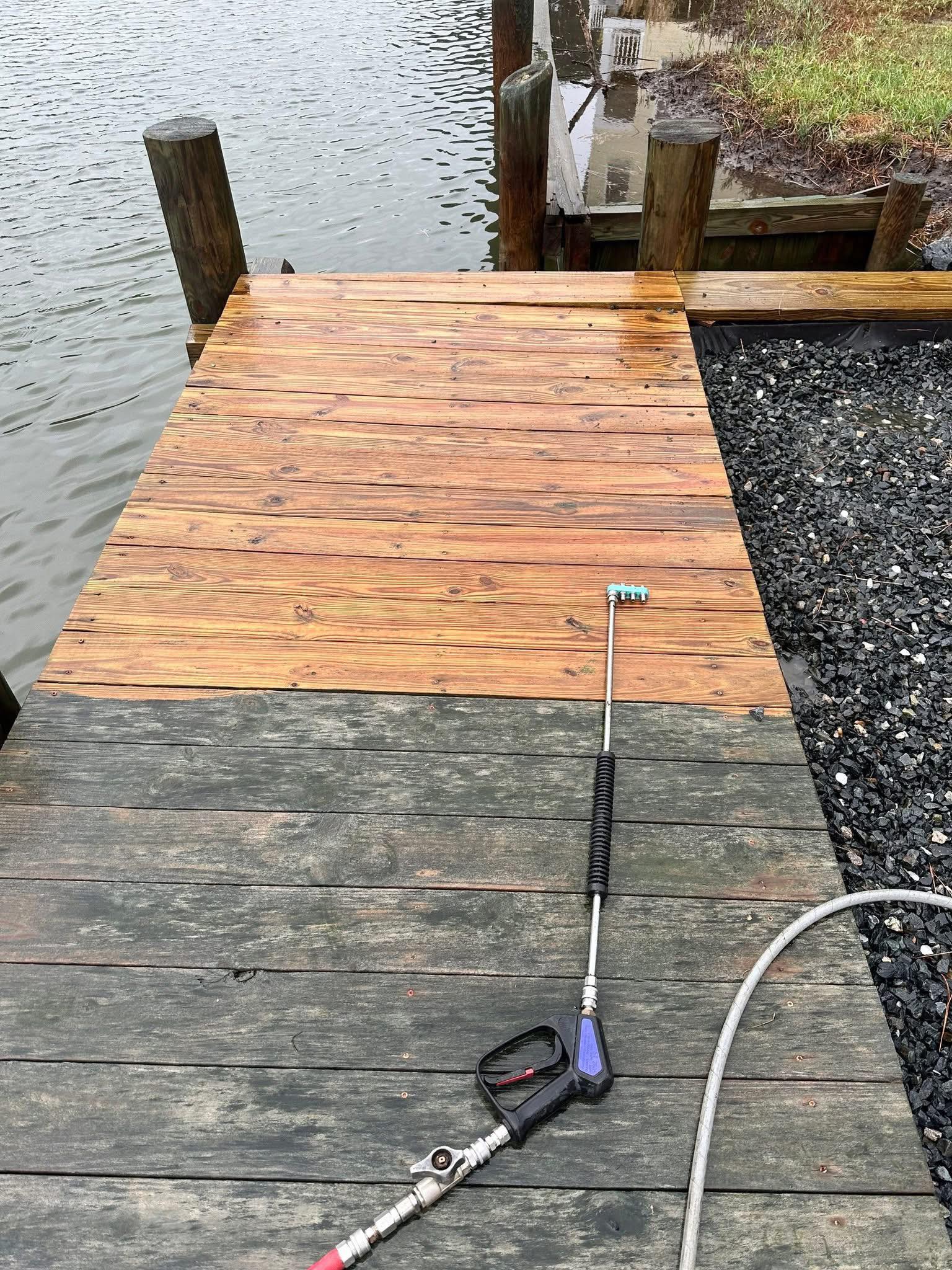 Wood dock pressure cleaning in progress